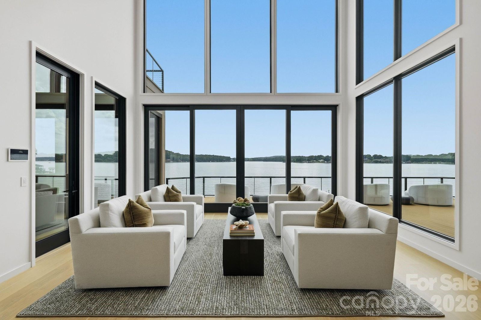 Two-story great room at 123 Cove Point with floor-to-ceiling windows facing Lake Tillery