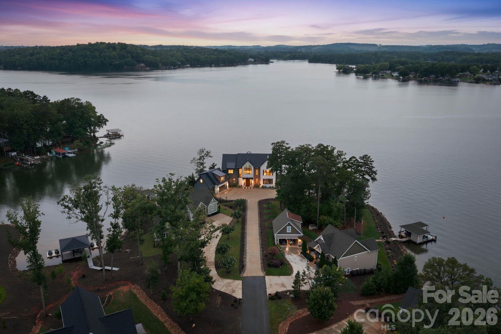 Wide aerial of Lake Tillery with 123 Cove Point lit at the end of its peninsula